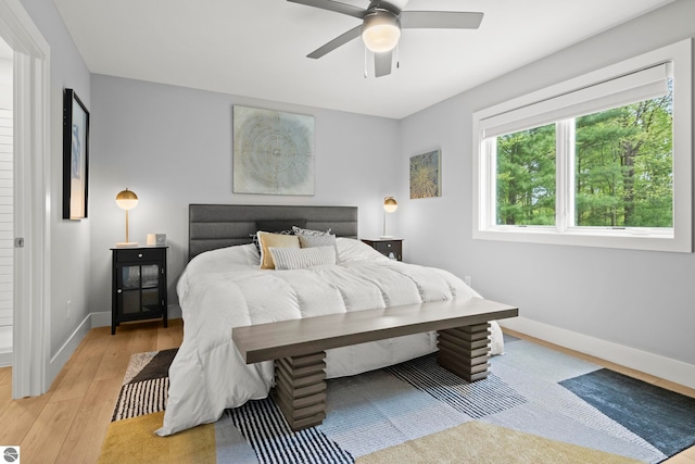 8906A Manhattan N Unit A, Traverse City, MI 49685 - bedroom featuring light wood-style floors, baseboards, and ceiling fan