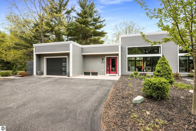 8906A Manhattan N Unit A, Traverse City, MI 49685 - contemporary house featuring a garage and asphalt driveway