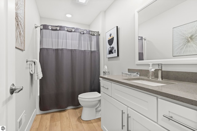 8906A Manhattan N Unit A, Traverse City, MI 49685 - full bathroom with toilet, vanity, and wood finished floors