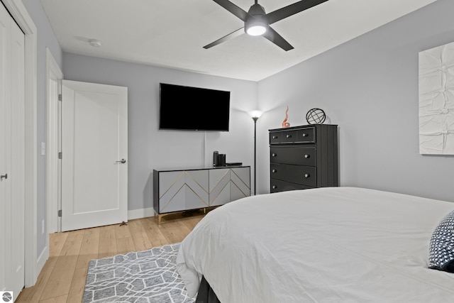 8906A Manhattan N Unit A, Traverse City, MI 49685 - bedroom with wood finished floors, ceiling fan, and baseboards