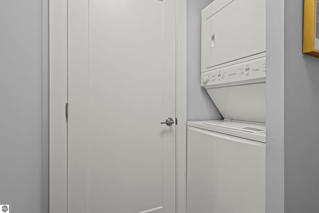 8906A Manhattan N Unit A, Traverse City, MI 49685 - laundry room featuring stacked washing machine and dryer