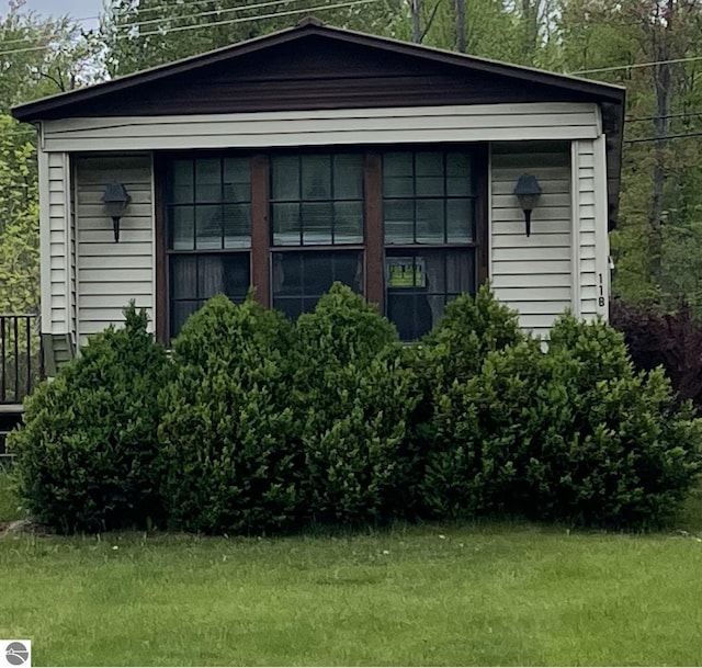 118 W Huron, Omer, MI 48749 - view of side of property featuring a lawn