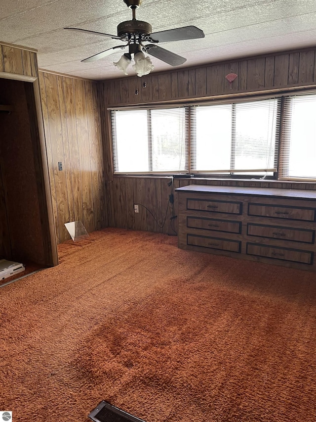 118 W Huron, Omer, MI 48749 - carpeted spare room featuring wood walls and a ceiling fan