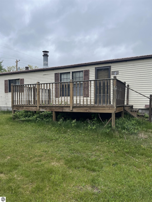 118 W Huron, Omer, MI 48749 - back of house featuring a wooden deck, a chimney, and a yard