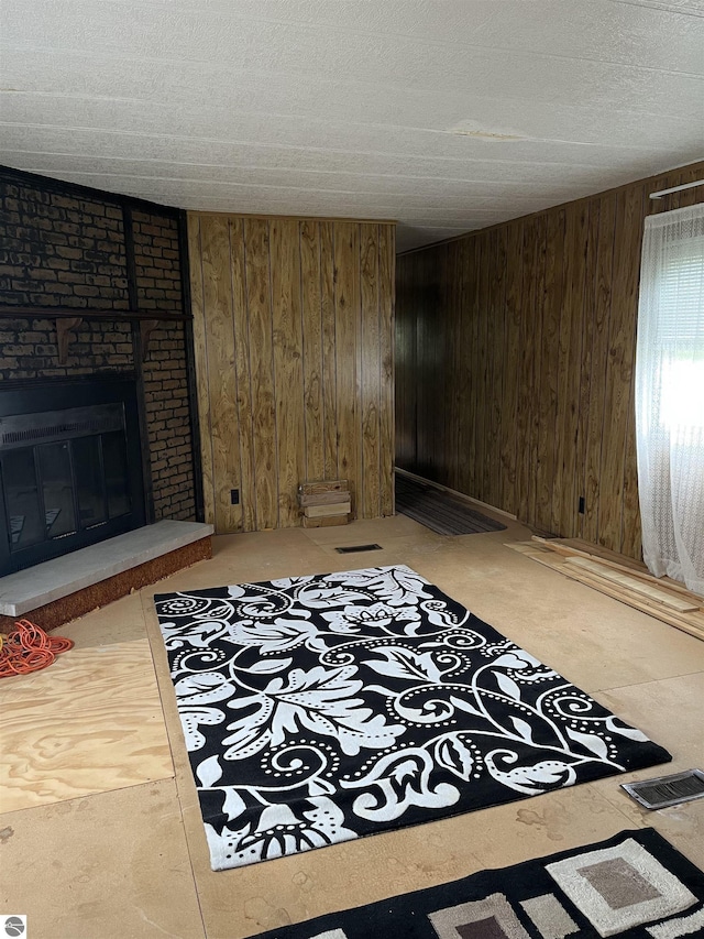 118 W Huron, Omer, MI 48749 - living room featuring wooden walls and a fireplace