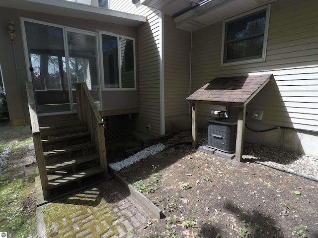 2118 E Lake Mitchell Dr, Cadillac, MI 49601 - view of patio / terrace featuring central air condition unit and entry steps