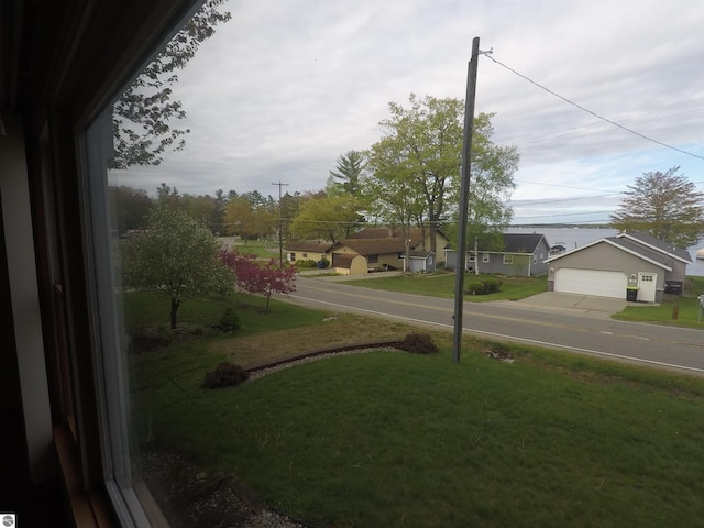2118 E Lake Mitchell Dr, Cadillac, MI 49601 - view of grassy yard featuring a detached garage and a residential view
