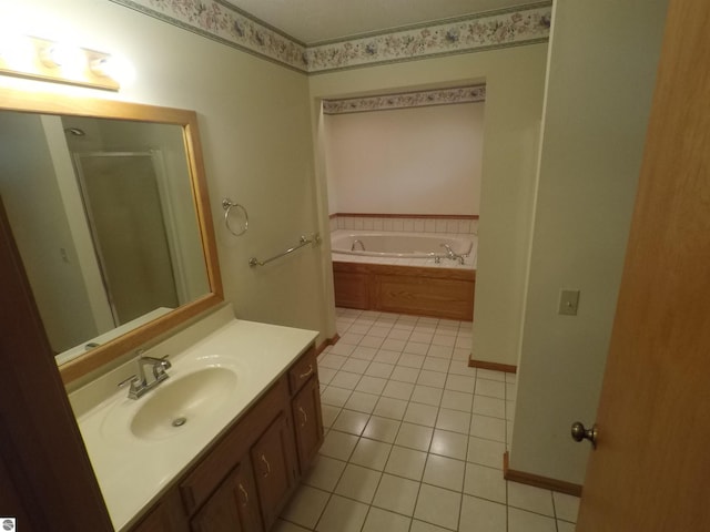 2118 E Lake Mitchell Dr, Cadillac, MI 49601 - bathroom featuring tile patterned flooring, vanity, a bath, and a shower stall