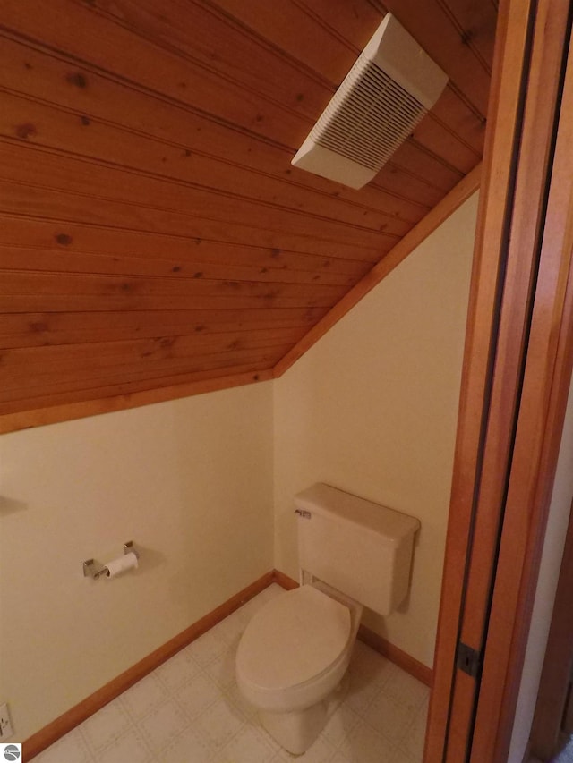 2118 E Lake Mitchell Dr, Cadillac, MI 49601 - bathroom with vaulted ceiling, wooden ceiling, toilet, tile patterned floors, and baseboards