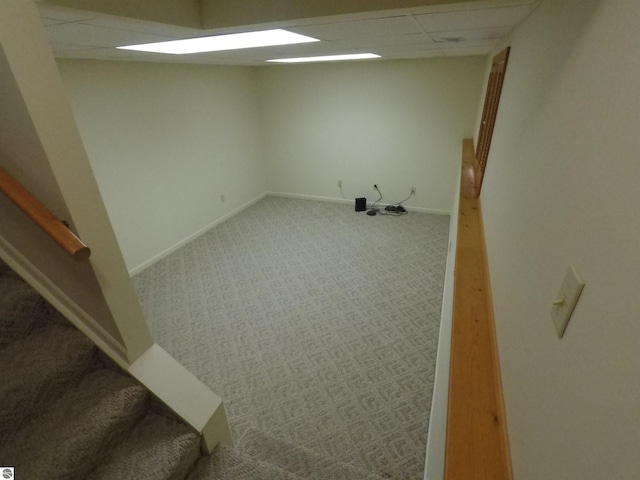 2118 E Lake Mitchell Dr, Cadillac, MI 49601 - below grade area with carpet, stairs, a paneled ceiling, and baseboards