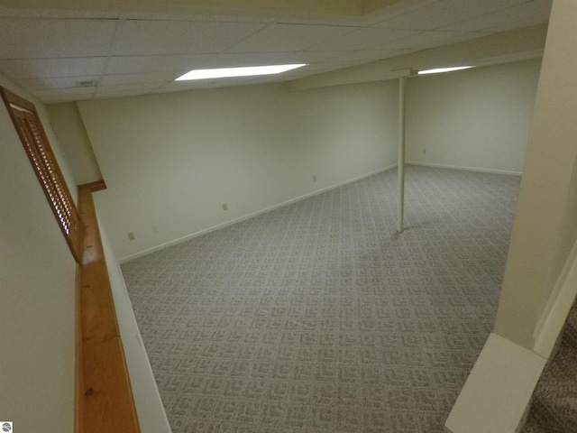 2118 E Lake Mitchell Dr, Cadillac, MI 49601 - finished basement with a paneled ceiling, carpet flooring, and baseboards