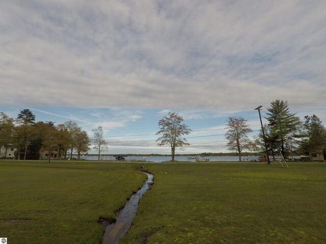 2118 E Lake Mitchell Dr, Cadillac, MI 49601 - view of grassy yard featuring a water view