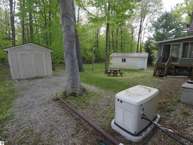 2118 E Lake Mitchell Dr, Cadillac, MI 49601 - view of green lawn with a sunroom