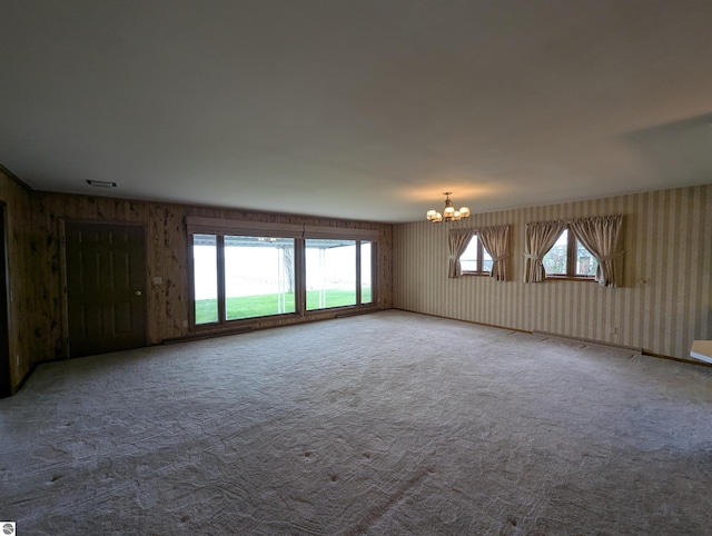 1082 S Sixth St, Au Gres, MI 48703 - carpeted spare room featuring a chandelier and healthy amount of natural light