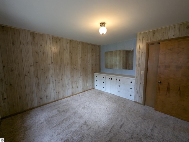 1082 S Sixth St, Au Gres, MI 48703 - unfurnished bedroom with carpet floors and wooden walls