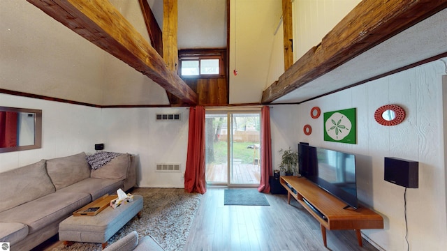 605 Cedar Ave, Houghton Lake, MI 48651 - living area featuring beam ceiling, wood finished floors, and a towering ceiling