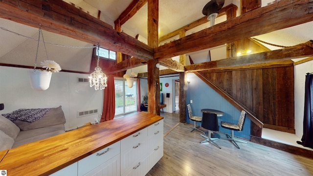 605 Cedar Ave, Houghton Lake, MI 48651 - bar area with hardwood / wood-style floors, a chandelier, and wooden walls