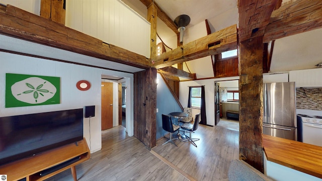 605 Cedar Ave, Houghton Lake, MI 48651 - office with high vaulted ceiling, hardwood / wood-style flooring, and wooden walls