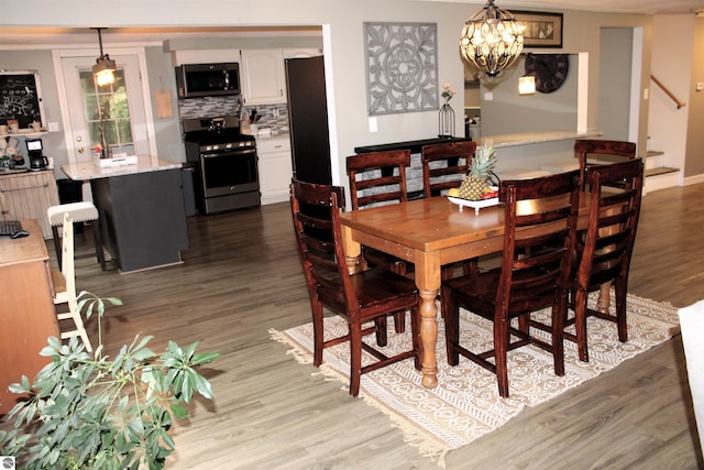 3690 Rau Rd, West Branch, MI 48661 - dining area featuring wood finished floors, stairway, and a chandelier