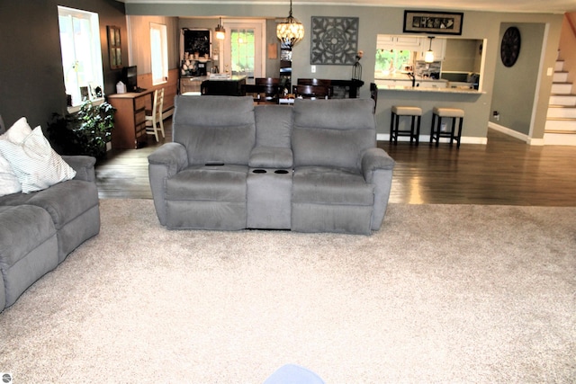 3690 Rau Rd, West Branch, MI 48661 - living area featuring wood finished floors, stairway, a chandelier, and baseboards