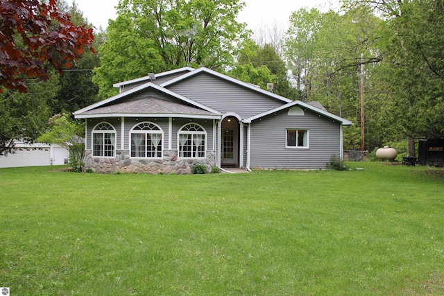 3690 Rau Rd, West Branch, MI 48661 - view of front facade featuring a front lawn and roof with shingles