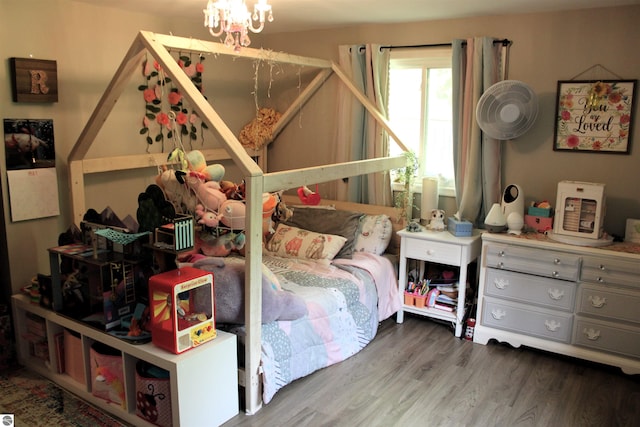 3690 Rau Rd, West Branch, MI 48661 - bedroom featuring wood finished floors and a chandelier