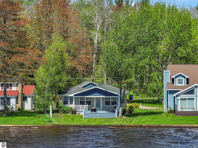 3151 W Lake Mitchell Dr, Cadillac, MI 49601 - rear view of house featuring a water view and a yard