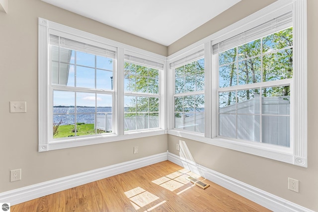 3151 W Lake Mitchell Dr, Cadillac, MI 49601 - unfurnished sunroom with a water view
