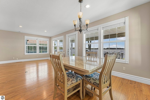 3151 W Lake Mitchell Dr, Cadillac, MI 49601 - dining space featuring baseboards, a chandelier, light wood-style flooring, and recessed lighting