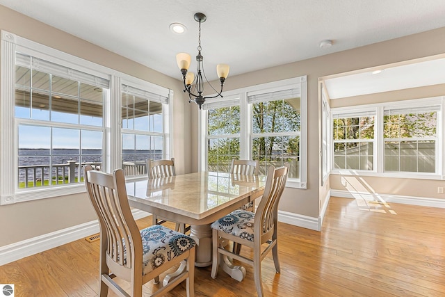 3151 W Lake Mitchell Dr, Cadillac, MI 49601 - dining area featuring baseboards, a chandelier, plenty of natural light, and recessed lighting