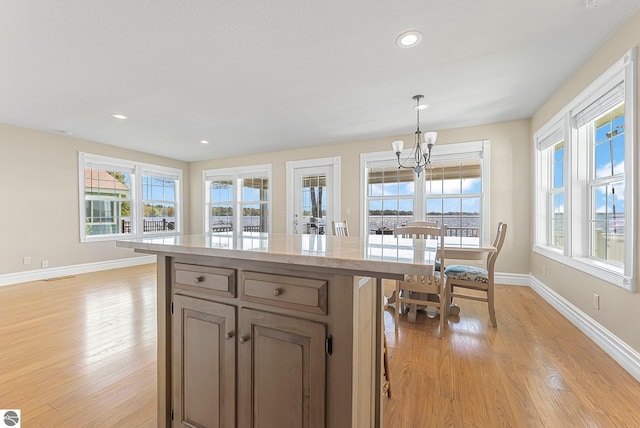 3151 W Lake Mitchell Dr, Cadillac, MI 49601 - kitchen featuring a chandelier, light wood finished floors, plenty of natural light, and recessed lighting