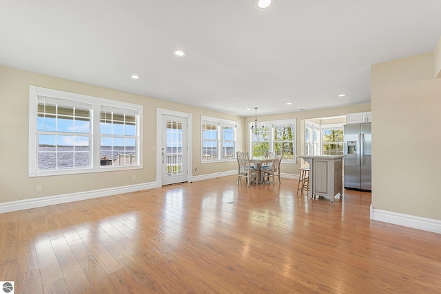 3151 W Lake Mitchell Dr, Cadillac, MI 49601 - living area with baseboards, light wood-style flooring, and recessed lighting