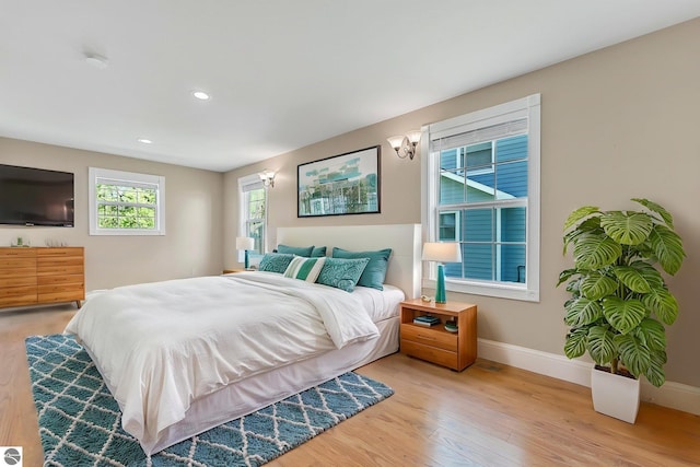 3151 W Lake Mitchell Dr, Cadillac, MI 49601 - bedroom featuring baseboards, light wood-style flooring, and recessed lighting