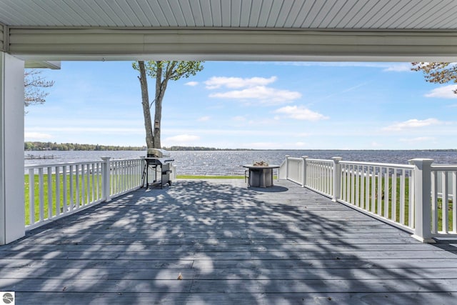 3151 W Lake Mitchell Dr, Cadillac, MI 49601 - wooden deck with a water view and grilling area