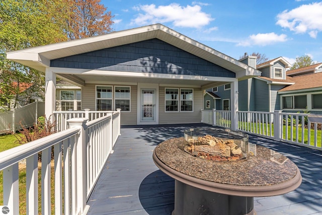3151 W Lake Mitchell Dr, Cadillac, MI 49601 - wooden deck featuring a fire pit
