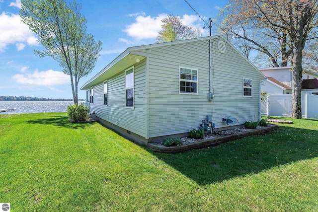 3151 W Lake Mitchell Dr, Cadillac, MI 49601 - view of home's exterior with a water view and crawl space