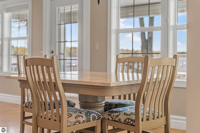 3151 W Lake Mitchell Dr, Cadillac, MI 49601 - dining area featuring healthy amount of natural light, baseboards, and wood finished floors