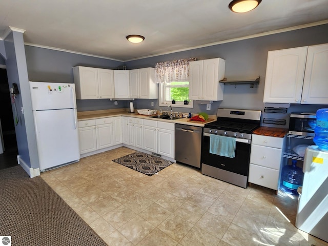 6878 Boss Rd, Ellsworth, MI 49727 - kitchen featuring appliances with stainless steel finishes, a sink, ornamental molding, and white cabinets
