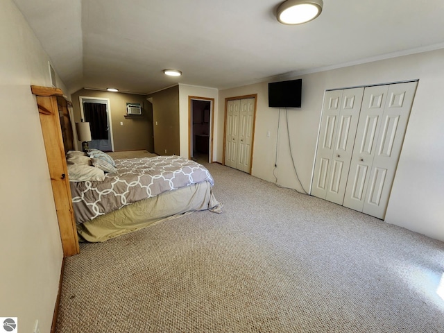 6878 Boss Rd, Ellsworth, MI 49727 - carpeted bedroom with a wall mounted AC, two closets, and ornamental molding