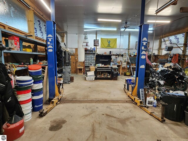 6878 Boss Rd, Ellsworth, MI 49727 - garage featuring a workshop area