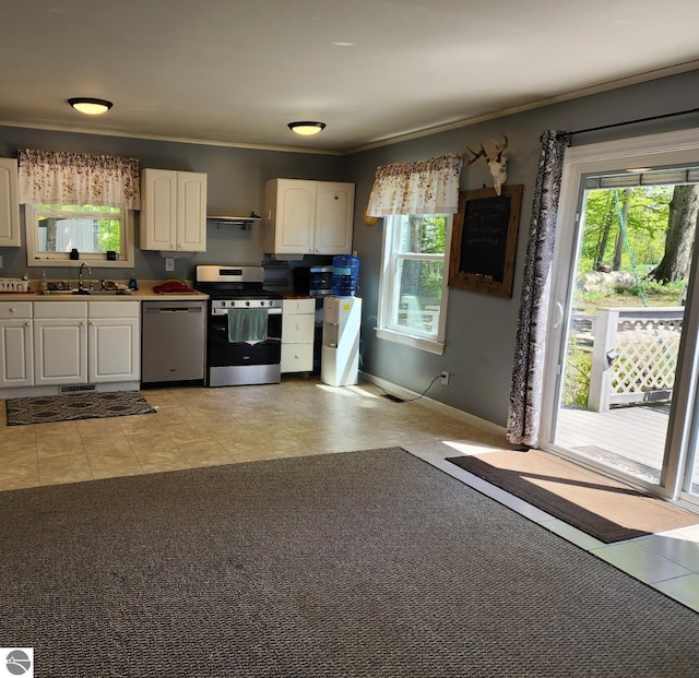 6878 Boss Rd, Ellsworth, MI 49727 - kitchen with stainless steel appliances, a sink, white cabinets, ornamental molding, and baseboards