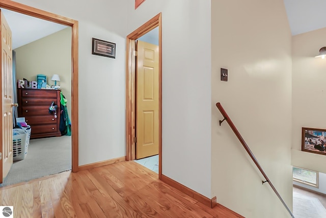 8281 M-66, Fife Lake, MI 49633 - hall with an upstairs landing, wood finished floors, baseboards, and lofted ceiling