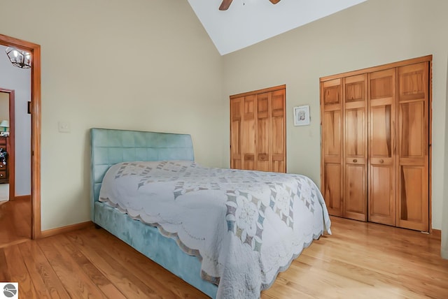 8281 M-66, Fife Lake, MI 49633 - bedroom featuring two closets, light wood-type flooring, high vaulted ceiling, baseboards, and a ceiling fan