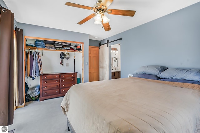 8281 M-66, Fife Lake, MI 49633 - bedroom with carpet, a barn door, a ceiling fan, and a closet