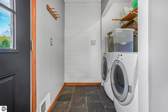 8281 M-66, Fife Lake, MI 49633 - laundry area with washing machine and dryer, baseboards, and dark stone finish floors