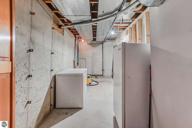 8281 M-66, Fife Lake, MI 49633 - unfinished below grade area with freestanding refrigerator