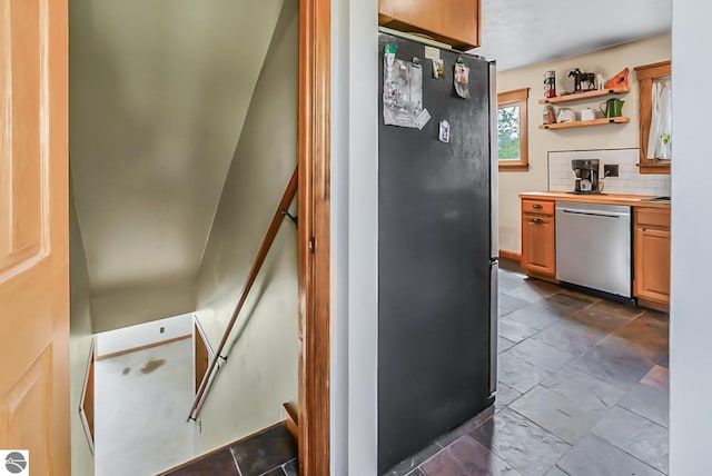 8281 M-66, Fife Lake, MI 49633 - kitchen with appliances with stainless steel finishes, decorative backsplash, wood counters, open shelves, and brown cabinetry