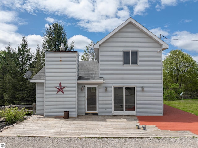 8281 M-66, Fife Lake, MI 49633 - rear view of house with a wooden deck, roof with shingles, and a chimney
