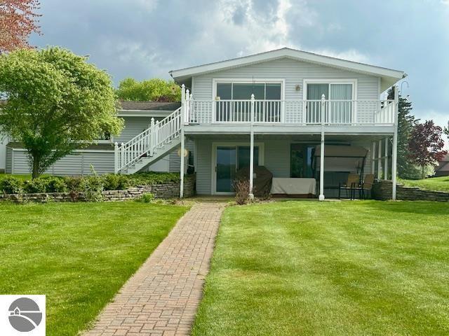 1094 Fairway Dr, Lake Isabella, MI 48893 - rear view of house with a yard, stairs, and a deck