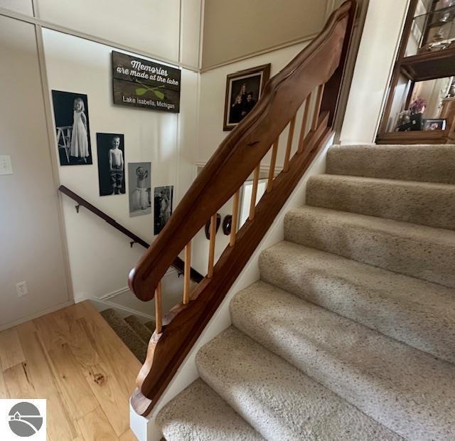 1094 Fairway Dr, Lake Isabella, MI 48893 - staircase with wood finished floors and baseboards